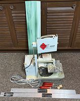 Front view of glass saw with accessories laid out