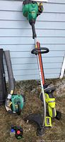Group shot of Weed Eater blower, Weed Eater string trimmer, Ryobi hedge trimmer, battery and charger