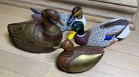 Four ducks: two brass-accented boxes and two painted decoys