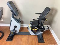 Full side view of recumbent bike showing frame, seat, pedals, and overall condition