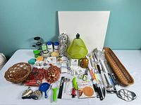 Overall view of entire kitchenware lot on table