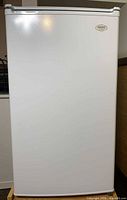 Front view of white Sanyo compact refrigerator closed