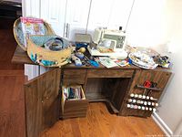 Overall view of sewing cabinet open, Kenmore machine on top, sewing basket, tools and notions visible