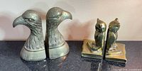 Eagle head and owl brass bookends grouped on countertop