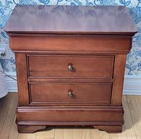 Front view showing entire nightstand, drawers, knobs, base