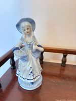 Single bonneted girl figurine showing front and details