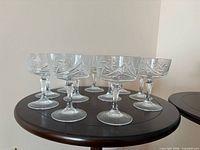 Front angled view showing eight of the ten Mount Royal coupe glasses, highlighting cut pattern and stem style