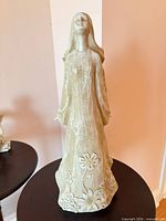 Front view of resin angel statue showing floral detailing