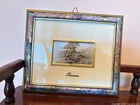 Front view of larger framed lithograph with marble-effect frame and cream mat
