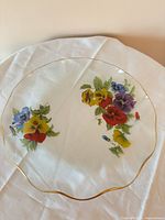 Top view showing full platter, pansy pattern and gold rim