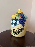 Full view of cookie jar showing fruit lid and basket weave body