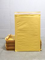Stack of yellow padded envelopes with one standing upright showing size