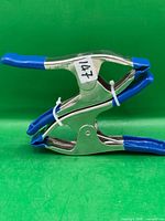 Two stacked Irwin metal spring clamps showing blue handles and jaws