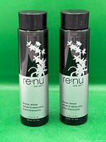 Front view of two Joico Renu Age Defy Renewal Serum bottles