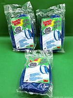 Front view of three sealed Scotch-Brite scrubber refills