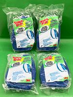 Front view of all four packaged scrubber refills