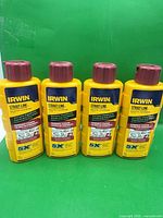 Front view of four Irwin Strait-Line red chalk bottles