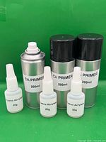 six containers: three 200 ml CA primer aerosol cans, three 20 g cyanoacrylate bottles