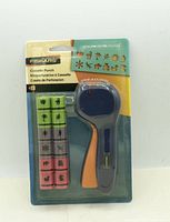 Front of sealed Fiskars cassette punch set showing handle and four cartridges