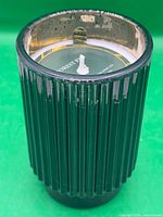 Dark green ribbed glass candle, top view showing unused wick