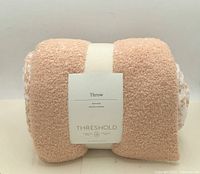 Rolled throw blanket front label visible