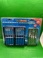 Front view of sealed ToolDeal 12-piece mini pick and tweezer set in blister packaging