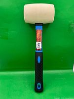 Front view of the mallet showing full length, white rubber head, blue fiberglass handle, black grip