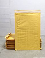 Stack of yellow padded envelopes standing and lying flat