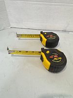 Two Fat-Pat tape measures extended to about 5 inches