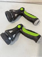 Two pistol-grip hose nozzles side view