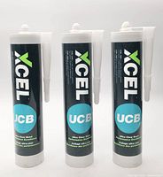 Front view of three XCEL UCB adhesive cartridges with nozzles