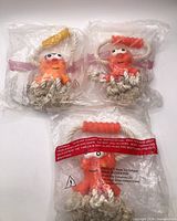Three sealed octopus rope dog toys in plastic bags