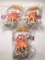 Front view of three packaged octopus rope toys