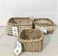 Three square jute baskets with tags front view