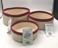 Front angled view of three Alkaso jute baskets with tags