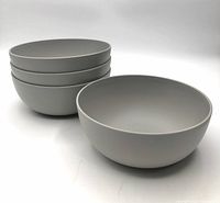 Stacked view of four identical light gray plastic bowls