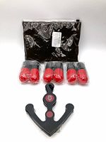 Anchor-style acrylic hanger, six shrink-wrapped pairs of red/black deodorizing capsules, clear zip pouch with black contents