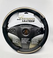 Front view of leather steering wheel cover in packaging