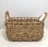 Front and side view of rectangular woven bulrush basket displaying weave and handles