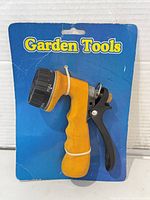 Front view of yellow handle hose nozzle on blue card