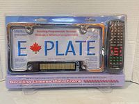 Front of sealed package showing license plate frame and remote control
