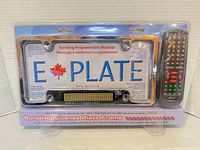 Front of sealed E-Plate package showing frame, LED display and remote