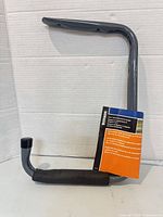 Full view of gray tubular Stinson shelf bracket & hanger with label attached