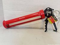 Full view of red Tooltech Xpert caulking gun