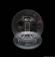 Front view showing stacked set of four clear glass plates on stand