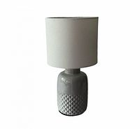 Front view of gray textured ceramic table lamp with shade