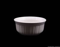 Side view of round white ribbed casserole