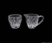 Gorham Star Blossom cut crystal open sugar bowl and creamer on black background