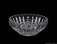 Top view of clear pressed glass bowl showing scalloped rim and lotus pattern
