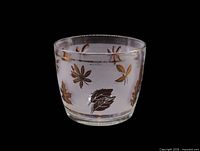 Full view of rounded ice bucket showing frosted glass and gold leaf design